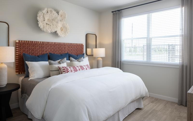 a bed with a flower on the wall