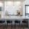a kitchen with a bar and chairs