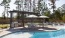 a pool with chairs and umbrellas by it