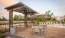 a pool with chairs and umbrellas by it