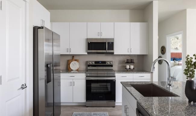 a kitchen with white cabinets