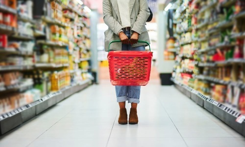 Shopping a woman holding a grocery store basket