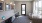a room with a desk and chairs