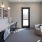 a room with a desk and chairs